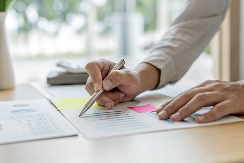 man writing sales commissioning paperwork
