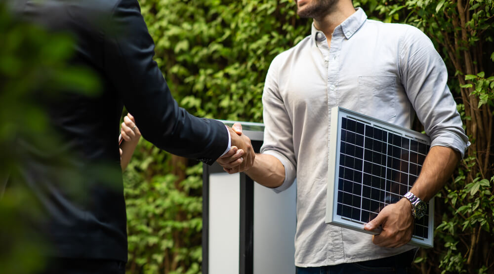 two men shake hands on solar energy consulting services