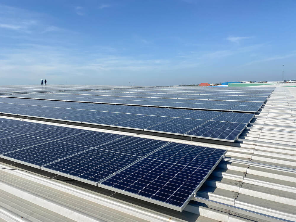 roof-top solar panels installed on an industrial warehouse building