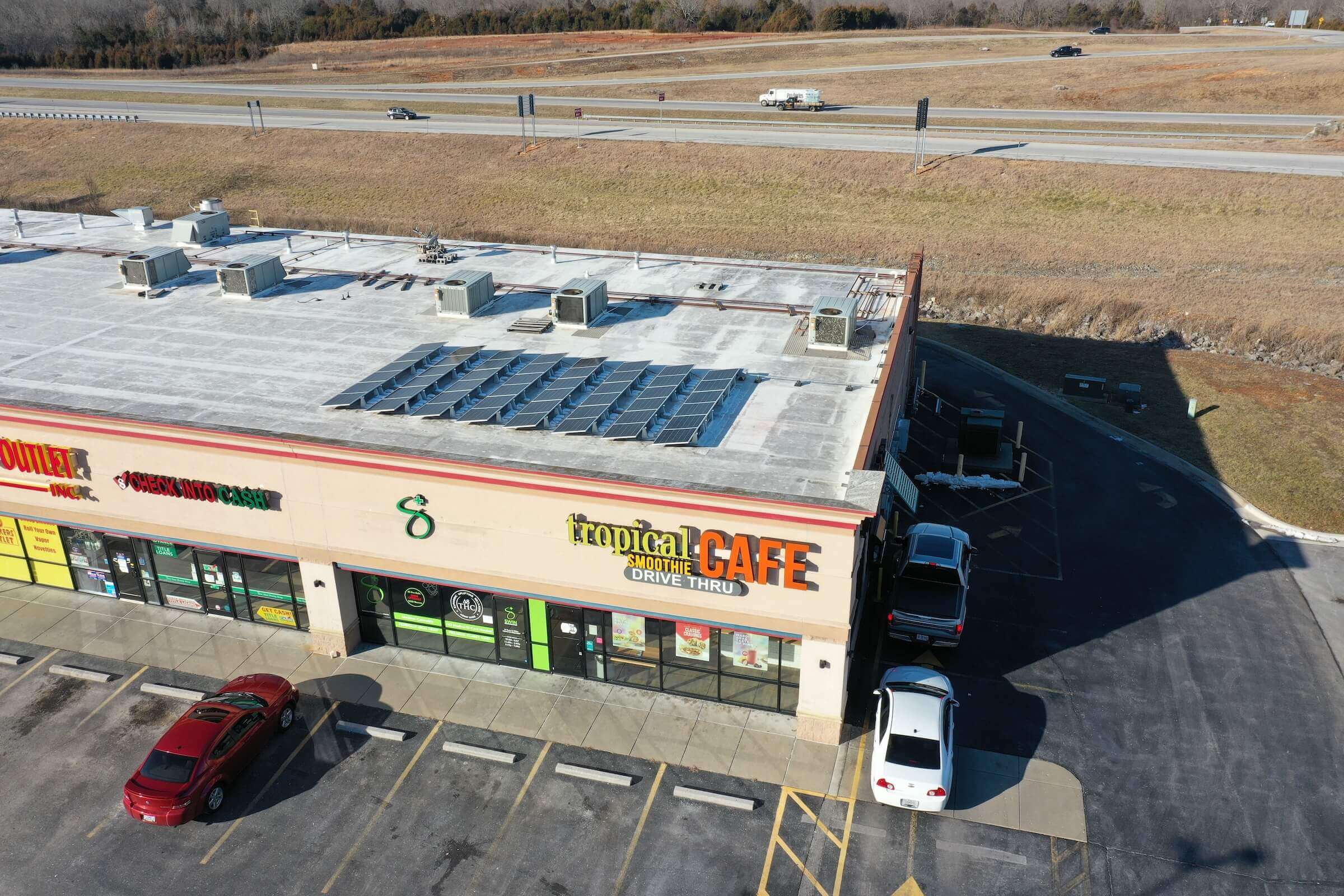 rooftop mounted solar panels at a tropical smoothie building