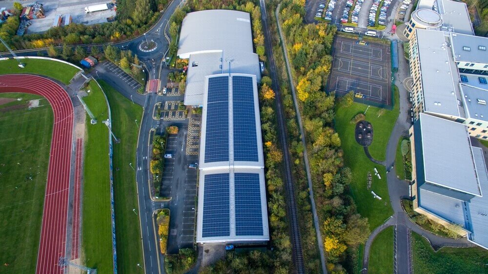 rooftop mounted solar panel system on a sports facility stadium