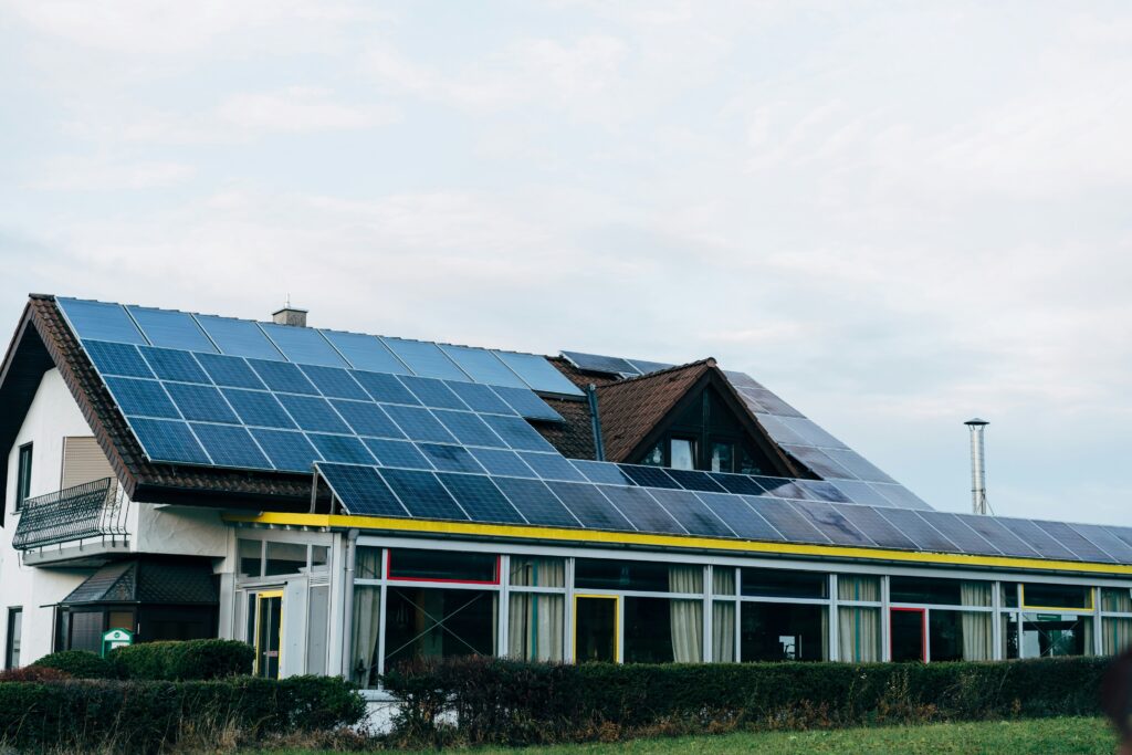A house with solar panels installed on the roof, illustrating the integration of photovoltaic systems for energy efficiency and the importance of accounting for solar panel depreciation.